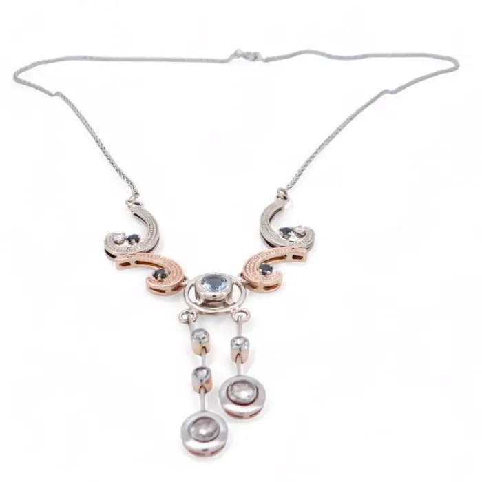Collier élégant bicolore avec motif central serti de pierres bleues et pendants mobiles