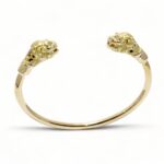 bracelet ouvert en or jaune 18 carats massif avec deux tête de lion serti de diamants dans les yeux